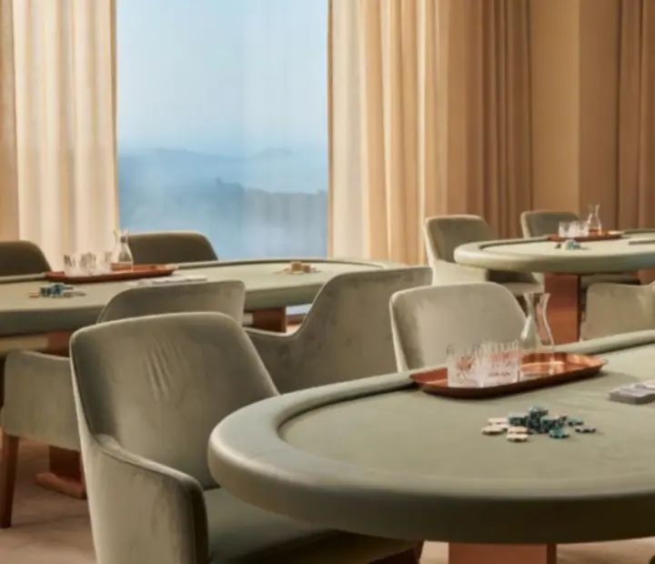 Private card room table set for an intimate poker event with linen and copper details.