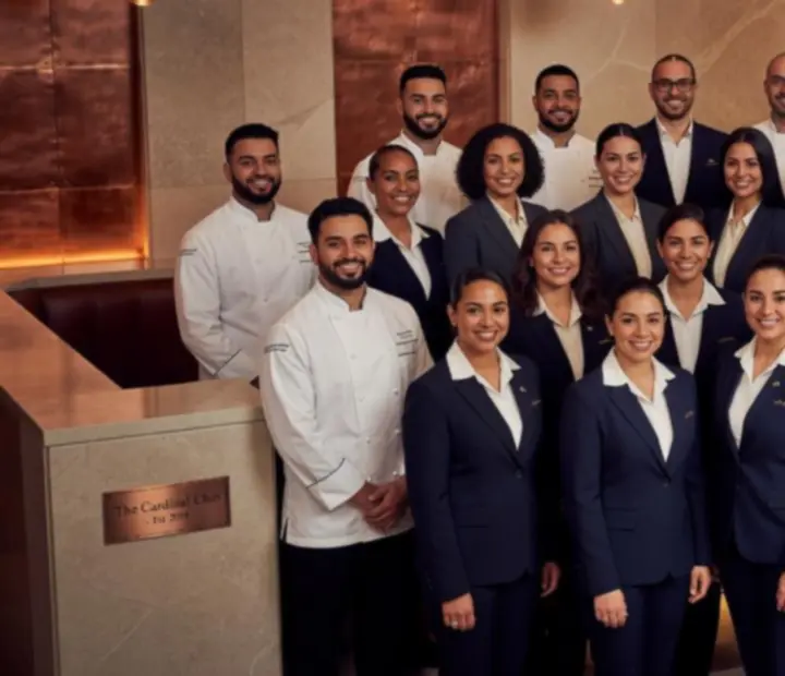 Restaurant and lounge team standing together in a modern dining room
